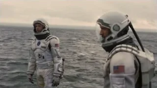 two astronauts standing near ocean — Interstellar