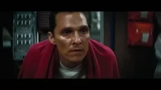 man in red robe with serious expression — Interstellar
