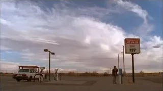 man looking at gas station sign — Breaking Bad