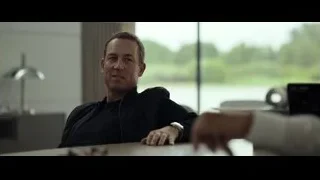 man smiling and gesturing at office desk — F1