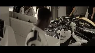 people working on Formula One race car — F1