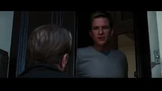 Man in grey sweater looking at another man — Batman: The Dark Knight Rises