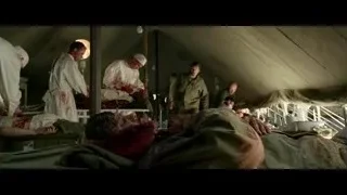 soldiers in military tent with injured man — Hacksaw Ridge