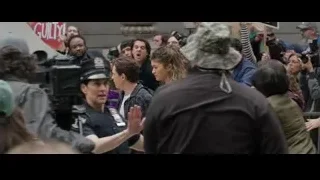 people protesting with hands raised — Spiderman: No Way Home