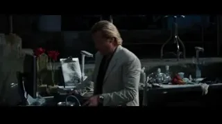 man at desk with computer and roses — Iron Man 3