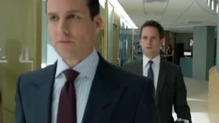 Man in suit walking through office — Suits
