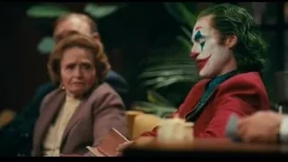 Joker at table with microphone — Joker