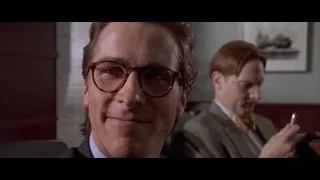 Man in suit with glasses smiling — American Psycho
