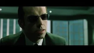 Man in suit and sunglasses speaking — The Matrix