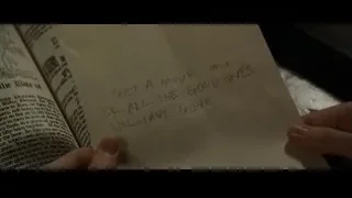 Hand holding open book with handwritten note — Harry Potter and the Goblet of Fire