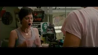 woman and man in room with poster — The Dictator