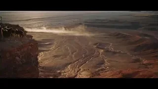 people on cliff overlooking sunset desert — Gladiator