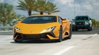 yellow sports car driving on highway cityscape — Sports Cars