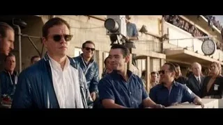 Group of men in front of crowd at stadium — Ford v Ferrari