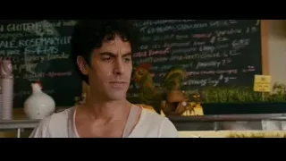 man with curly hair at menu blackboard — The Dictator
