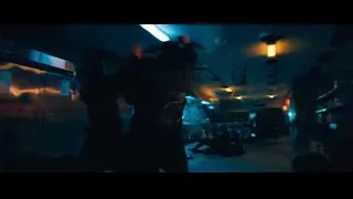two men holding guns with city view — John Wick: Chapter 4