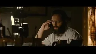 man with beard on phone at desk — The Dictator
