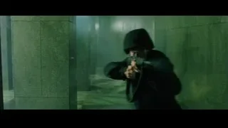 man in black suit crouching in concrete room — The Matrix