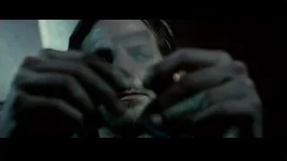 man with serious expression, hands covering mouth — Limitless