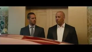 two men in suits by red sports car — Furious Seven