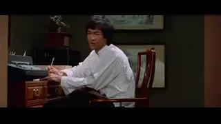 Man holding chopsticks at desk — Bruce Lee: Enter The Dragon