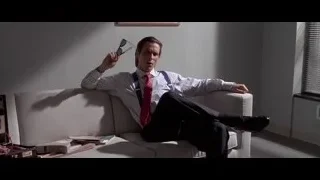 Man on couch holding cigar pipe — American Psycho