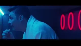 man in white robe with neon sign — John Wick