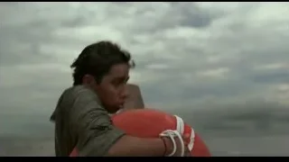 person in distress holding red lifebuoy — Life of Pi