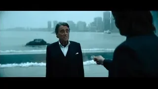 man in suit on balcony overlooking city — John Wick: Chapter 4