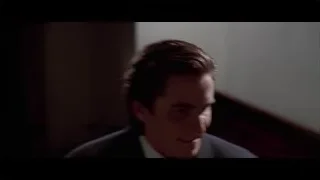close-up man's face in dark suit — American Psycho
