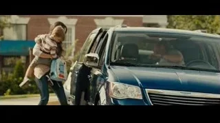 woman carrying boy in front of blue car — Furious Seven