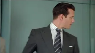 Two men in suits conversing — Suits