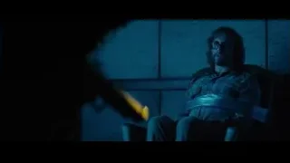 Man sitting in dimly lit room — Deadpool 2