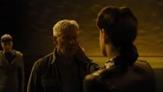 man deep in thought with woman watching — Blade Runner 2049