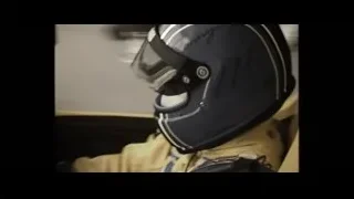 person in racing helmet sitting in yellow car — F1