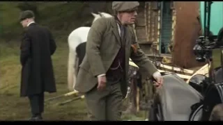 man in green suit leaning on vintage car — Peaky Blinders