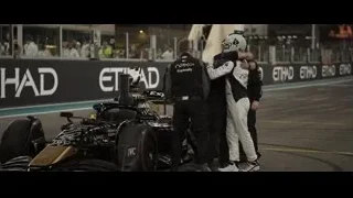 men around Formula One car at night — F1