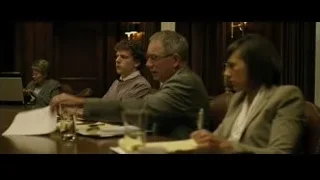 Four people discussing at conference table — The Social Network