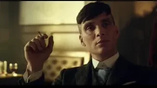 man in suit holding cigarette in dimly lit room — Peaky Blinders