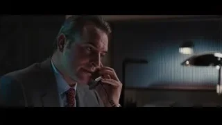 man in suit at desk talking on phone — The Wolf Of Wall Street