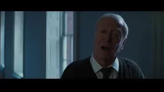 Elderly man standing in dimly lit room — Batman: The Dark Knight Rises