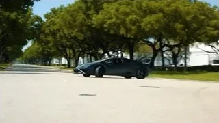 black sports car driving on street — Sports Cars