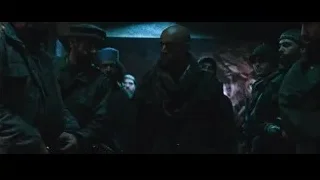 men in military uniforms holding guns in a dark cave — Iron Man
