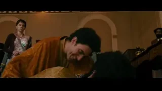 man in golden robe lying on bed in ornate room — The Dictator