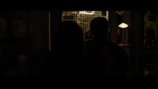 Man and woman in dimly lit bar — Batman: The Dark Knight Rises