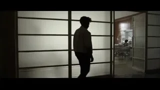 silhouette of men walking in dimly lit room — F1