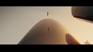 person flying above cylindrical building at sunset — Furious Seven