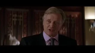 Older man looking serious in dim room — Batman