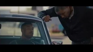 man resting head on steering wheel in car — Creed 2