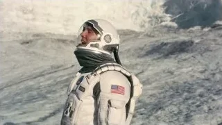 man in space suit on rocky mountain surface — Interstellar